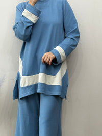Blue outfit with white stripes on a plain background
